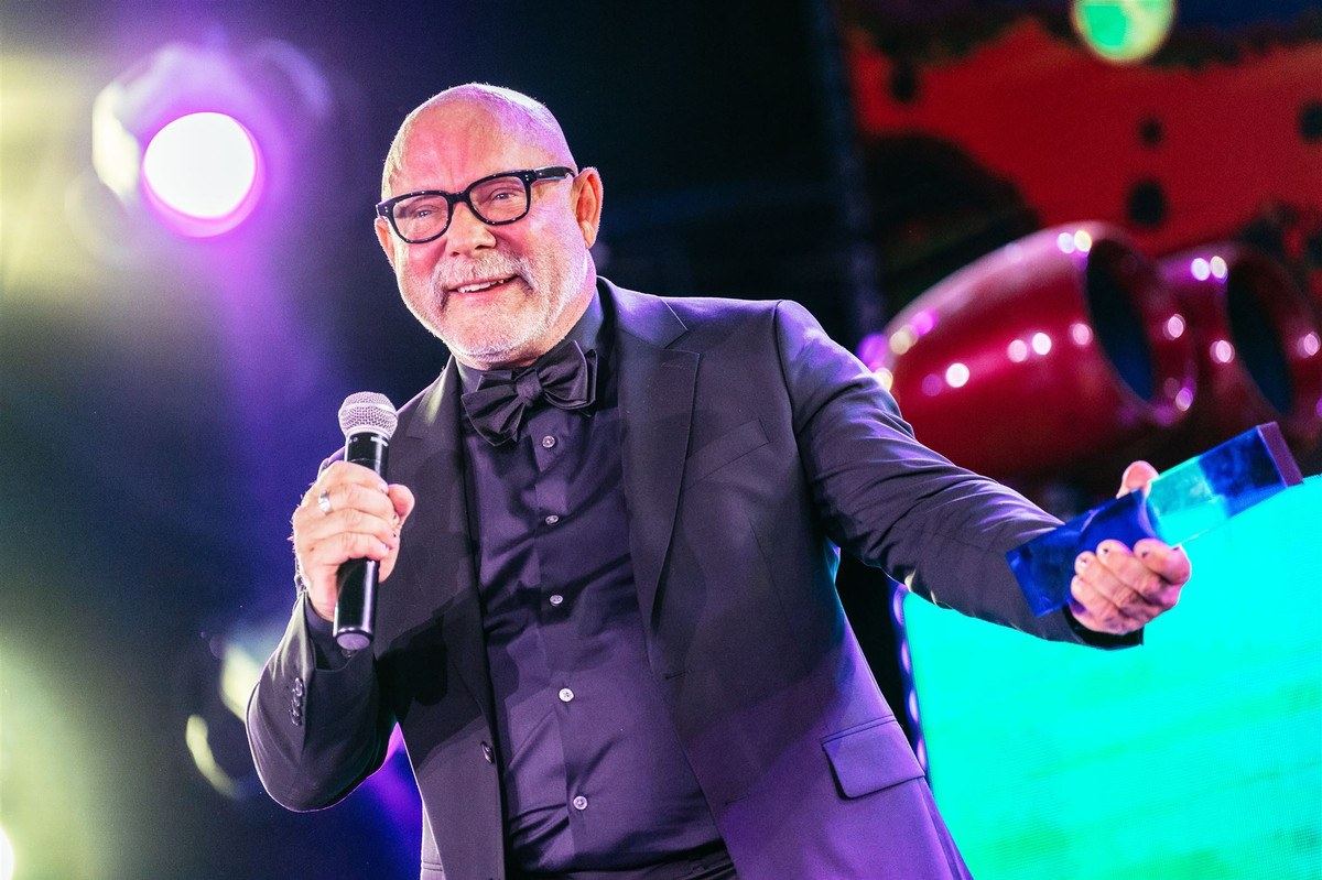 The host on stage at an LA Gayla, mic in hand