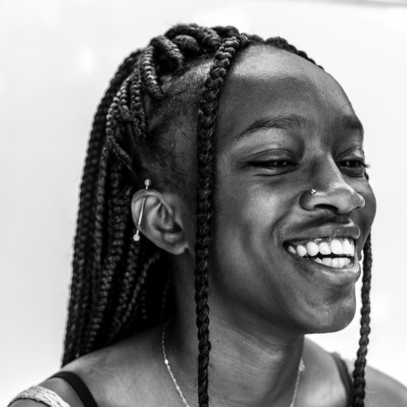 A young person from OUTMemphis with long braids, laughing